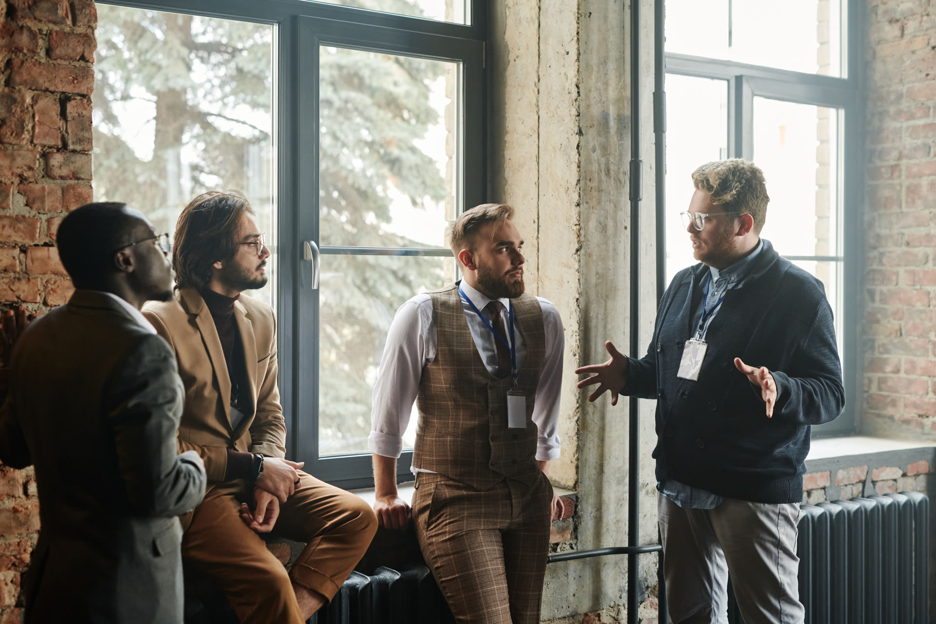 Four people talking together in a bright industrial space