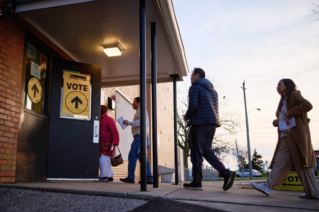 People entering a polling station marked Vote