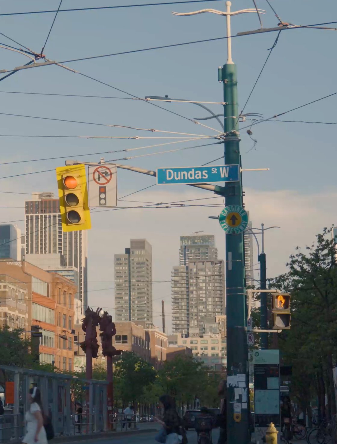 Dundas Street West in Toronto, with streetcar wires and downtown towers